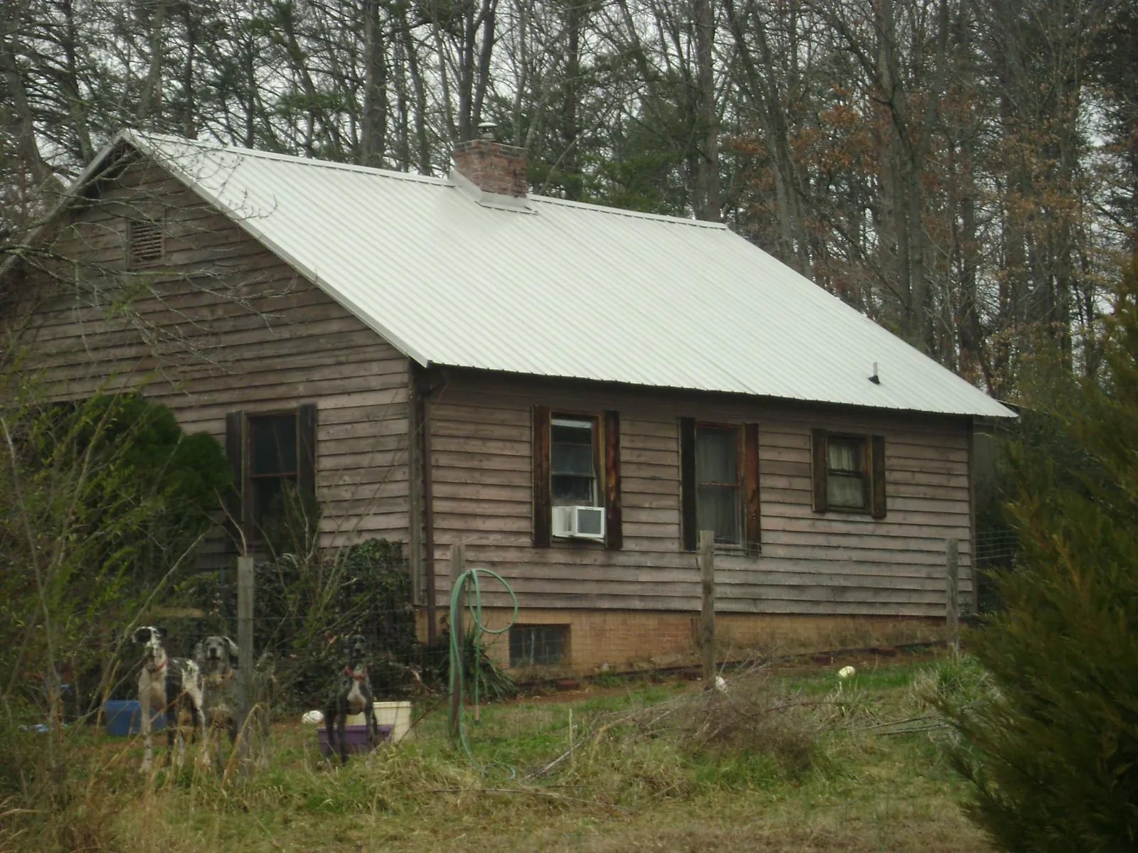 White metal roof on an old wood sided farmhouse, from a Metal Roof Installation job in Ellinger